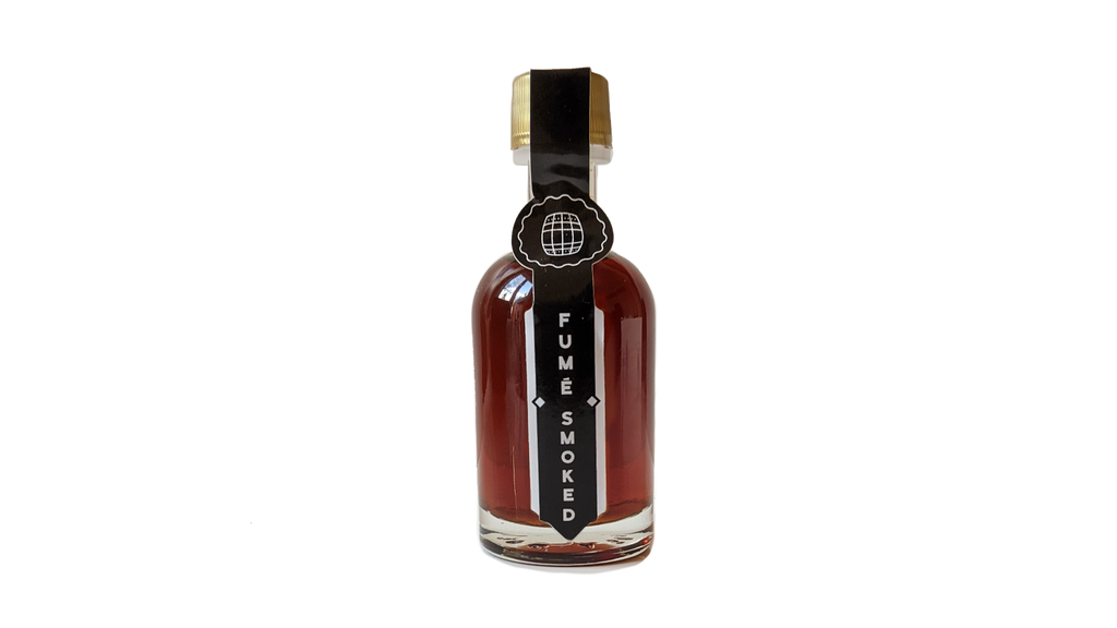 Small bottle of Smoked Maple Sirup with maple wood